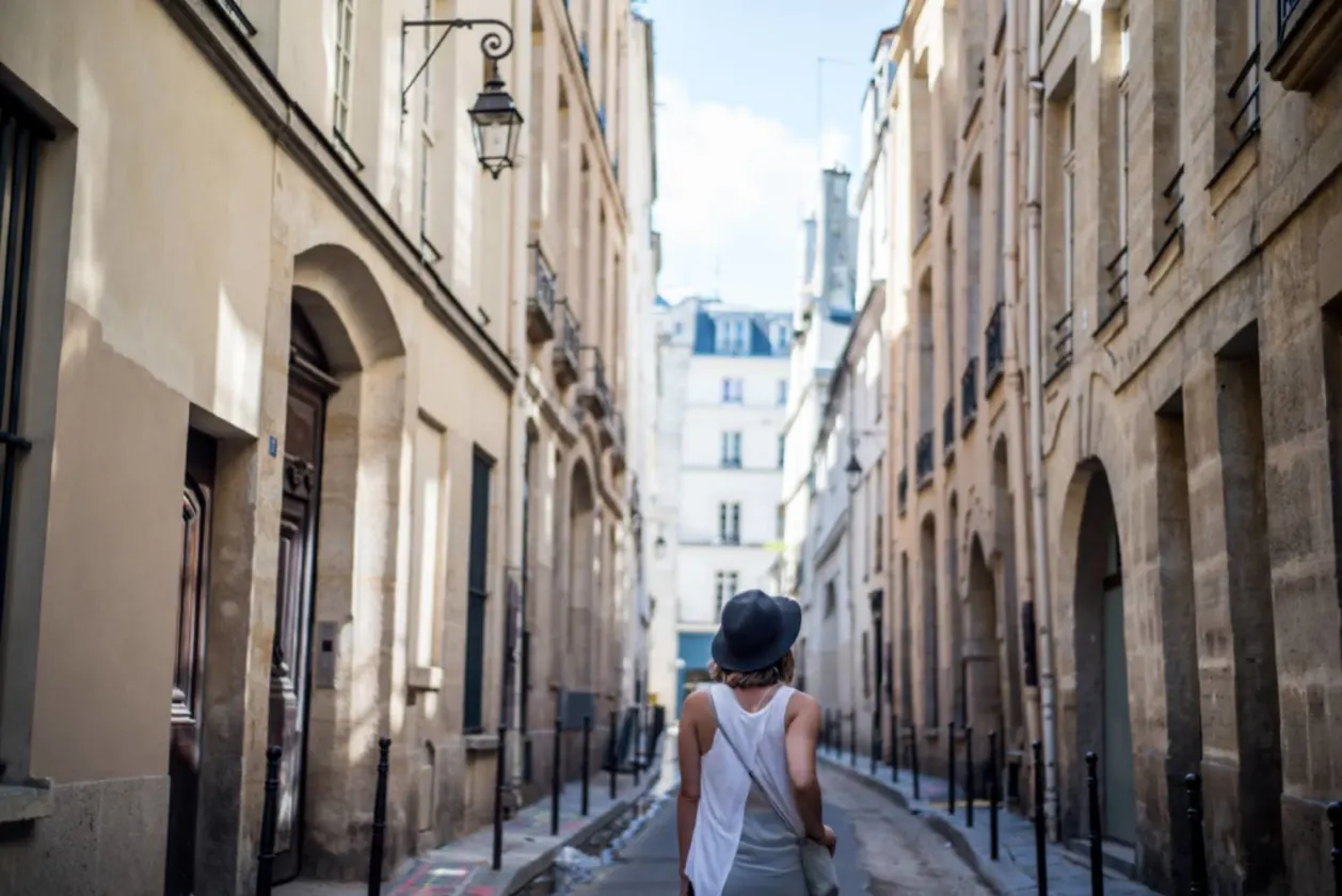 Woman exploring streets of Paris France — wellness travel tip concept